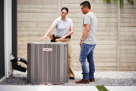 HVAC technician explaining to homeowner if heat pump is worth it