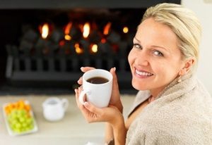 Woman cozy by the fire